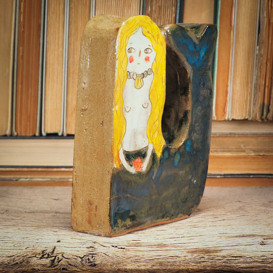 This little mermaid is a little shy, but she is beautiful and perfect to live on a shelf where she can command her realm An original sculpture by Idania Salcido