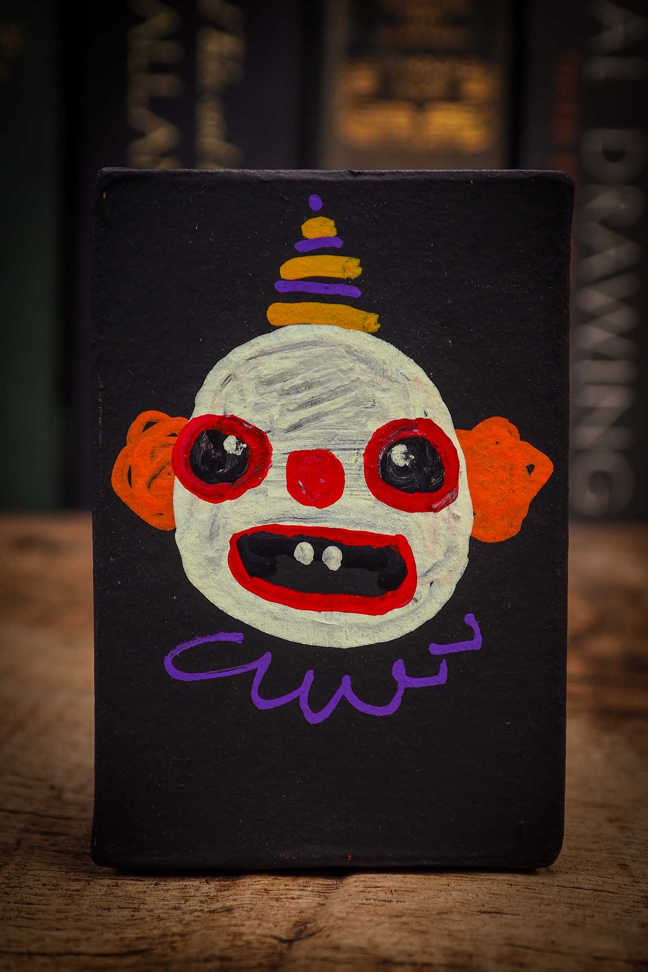 Small Halloween mini kokeshi art doll evil it pennywise clown figurine with painted makeup, orange polka dot body and party hat. Made by Idania Salcido, Danita Art.