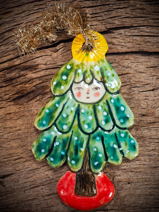 Handmade ceramic Christmas tree figure ornament with painted face and snowy details, created by Idania Salcido Danita Art for holiday decoration or gifting.