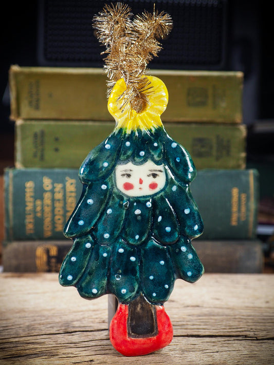 Handmade ceramic Christmas tree figure ornament with painted face and snowy details, created by Idania Salcido Danita Art for holiday decoration or gifting.