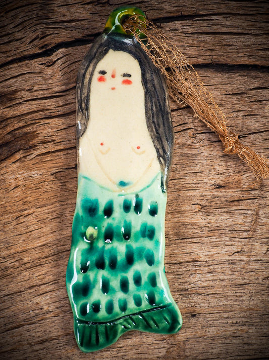 Handmade ceramic mermaid ornament with golden hair and blue-green tail, created by Idania Salcido aka Danita Art for holiday decorating or gifting.