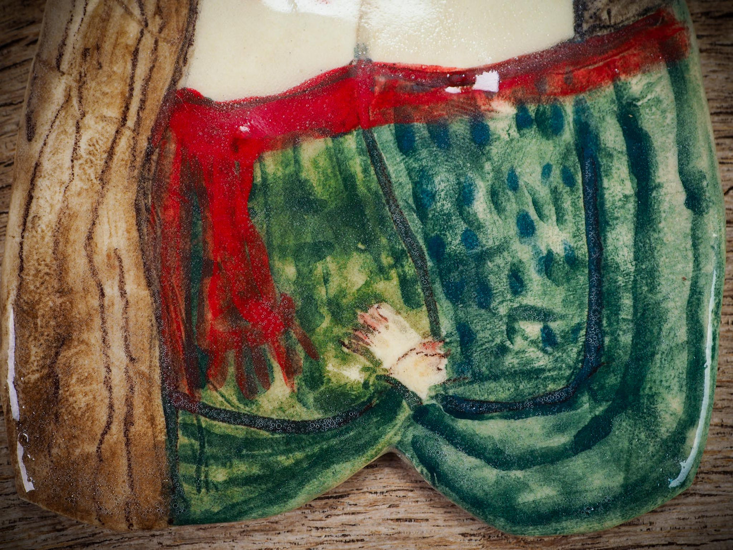 Handmade ceramic winter couple ornament with painted scarves and ribbon, created by Idania Salcido aka Danita Art for Christmas decoration or gifting.