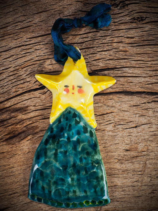Handmade ceramic star figure ornament with painted face and blue-green gown, created by Idania Salcido Danita Art for Christmas decorating or gifting.