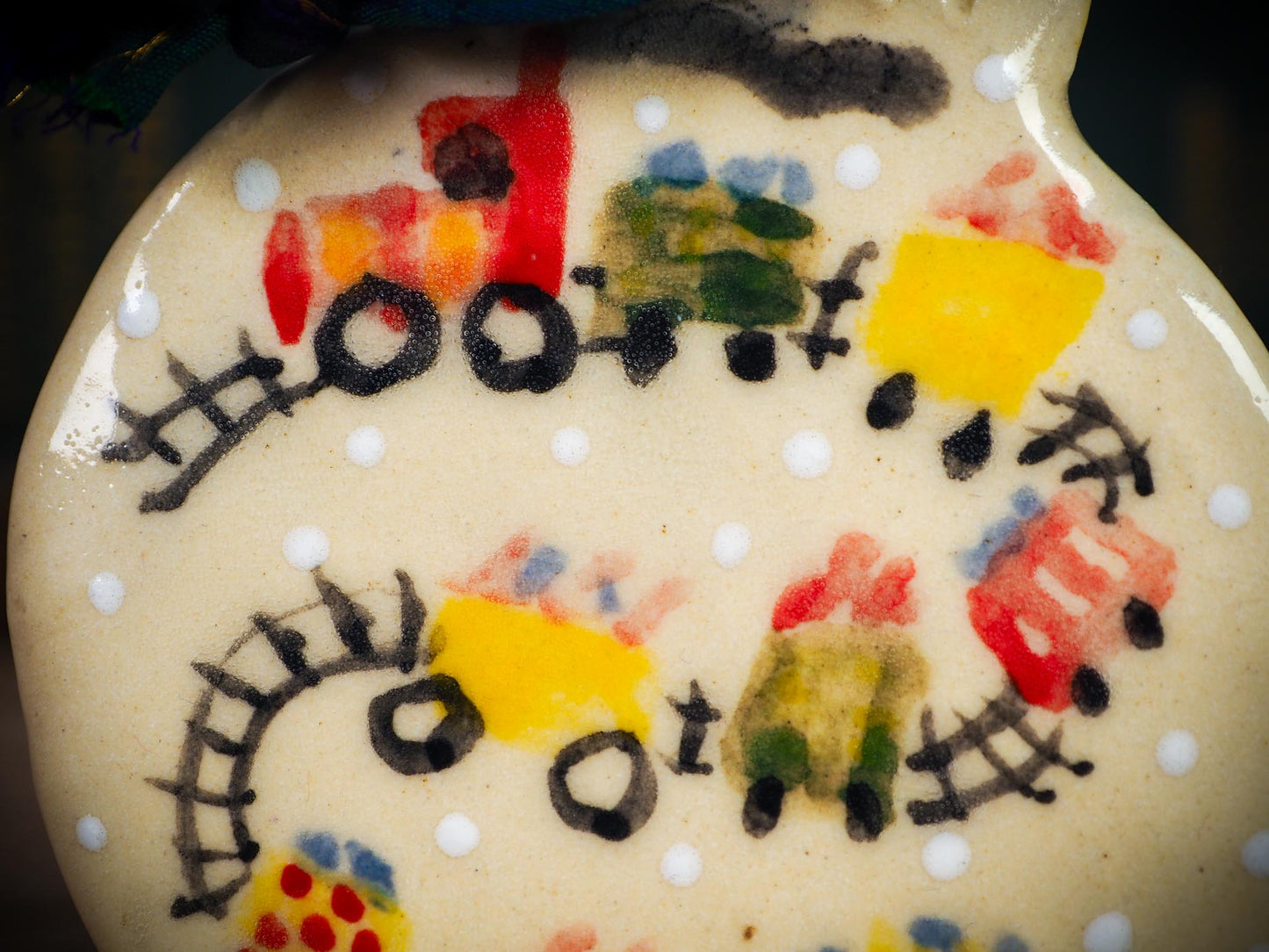 Handmade ceramic holiday train ornament with colorful cars and snowy details, created by Idania Salcido aka Danita Art for Christmas decoration or gifting.