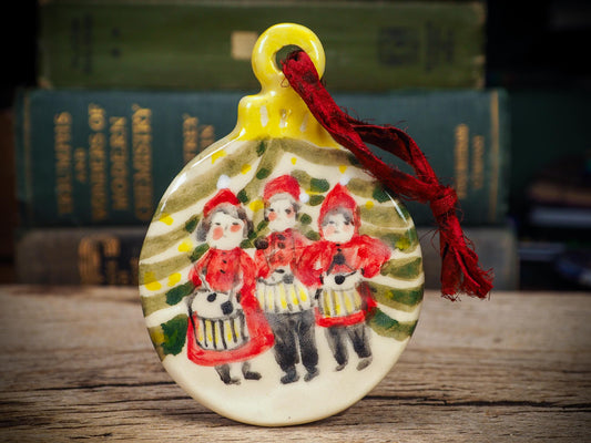 Handmade ceramic Little Drummers ornament with red outfits and yellow drums, created by Idania Salcido aka Danita Art for Christmas decorating or gifting.