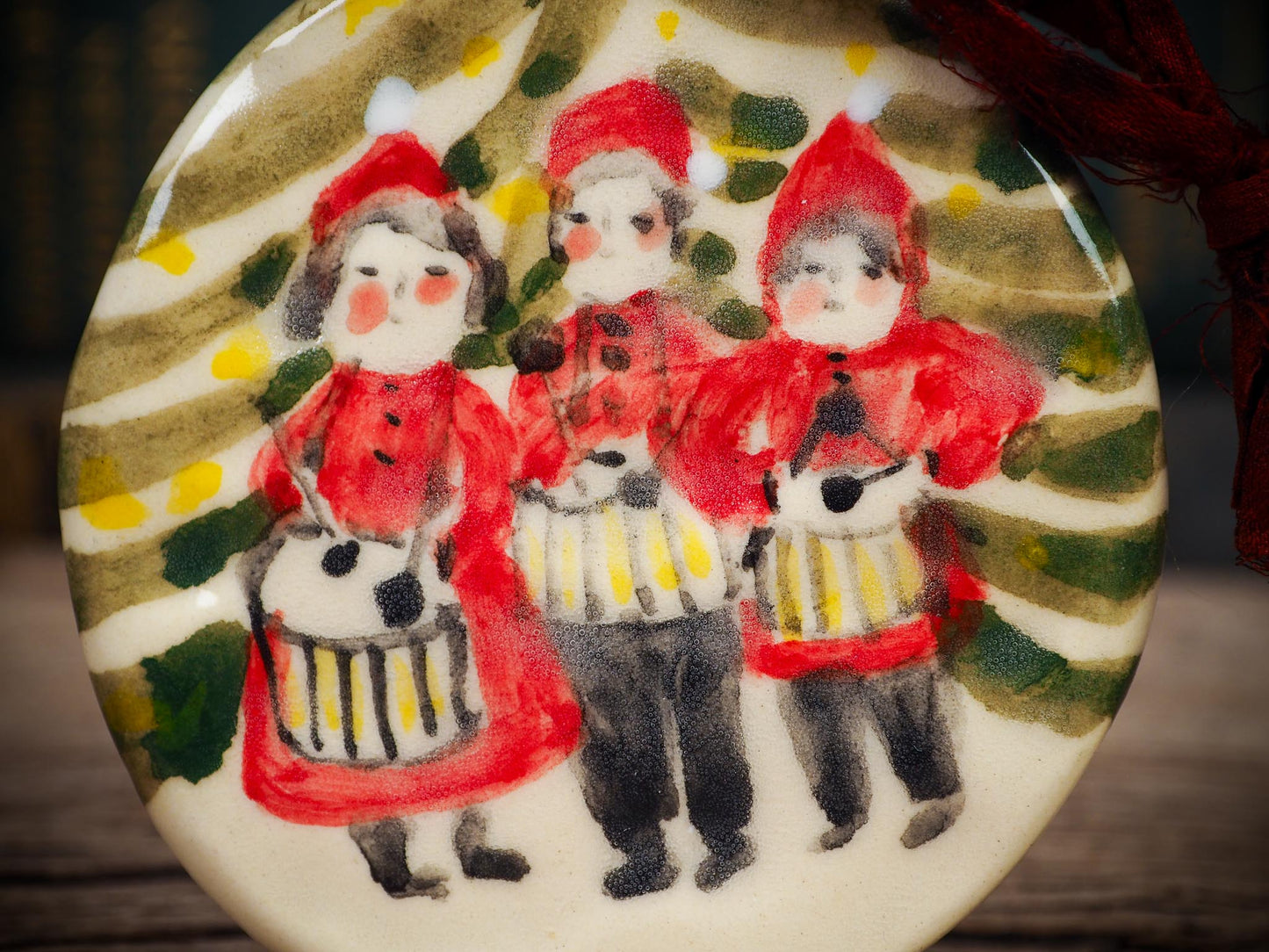 Handmade ceramic Little Drummers ornament with red outfits and yellow drums, created by Idania Salcido aka Danita Art for Christmas decorating or gifting.