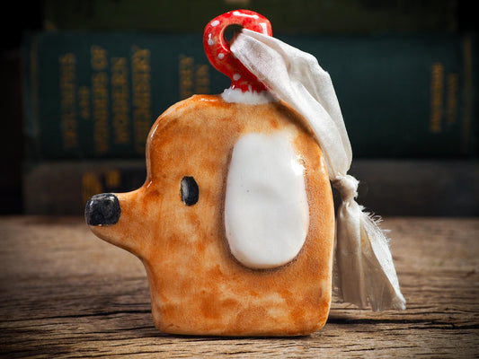 Handmade ceramic dog ornament with winter hoodie, created by Idania Salcido aka Danita Art for Christmas decorating or gifting.