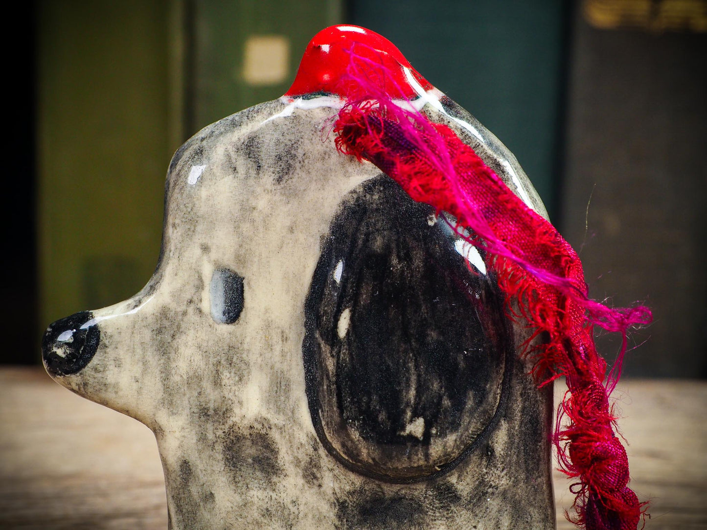 Handmade ceramic dog ornament with winter hoodie, created by Idania Salcido aka Danita Art for Christmas decorating or gifting.