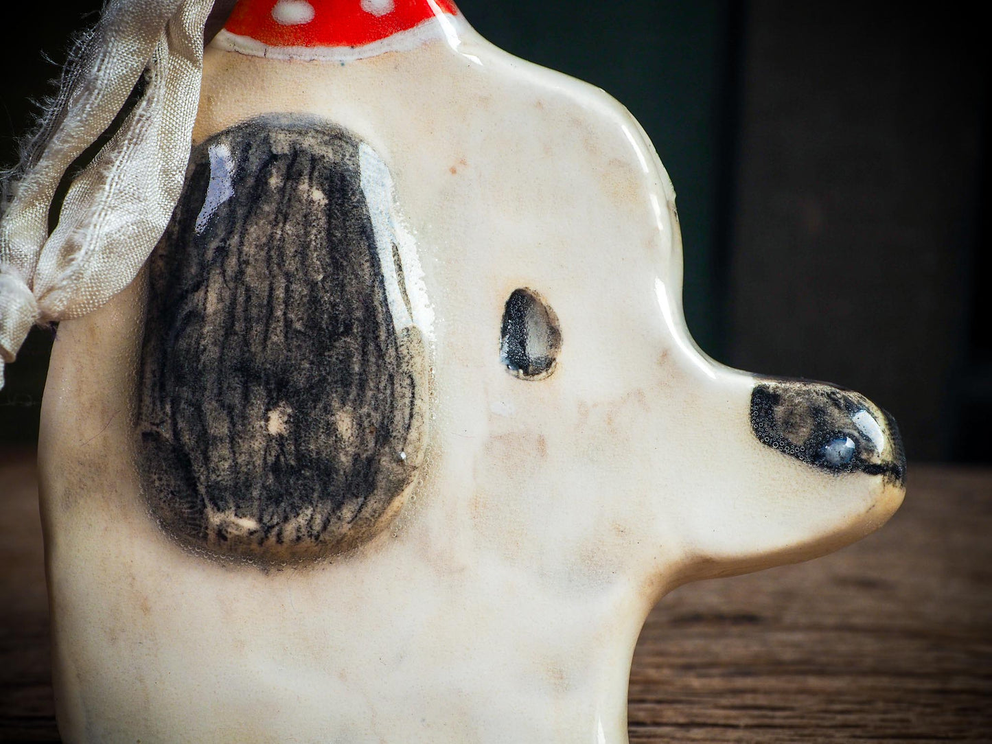 Handmade ceramic dog ornament with winter hoodie, created by Idania Salcido aka Danita Art for Christmas decorating or gifting.