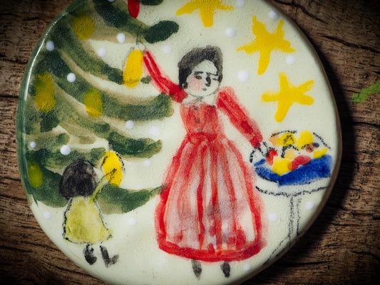 Handmade ceramic ornament of a mother and child decorating a Christmas tree by Idania Salcido aka Danita Art.