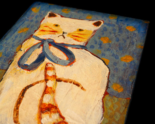 THE CAT WITH THE BLUE RIBBON