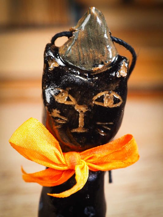 Original handmade ceramic black cat ornament by Idania Salcido Danita Art with silk bow is perfect Halloween decoration! Stands on its own or hangs from window.