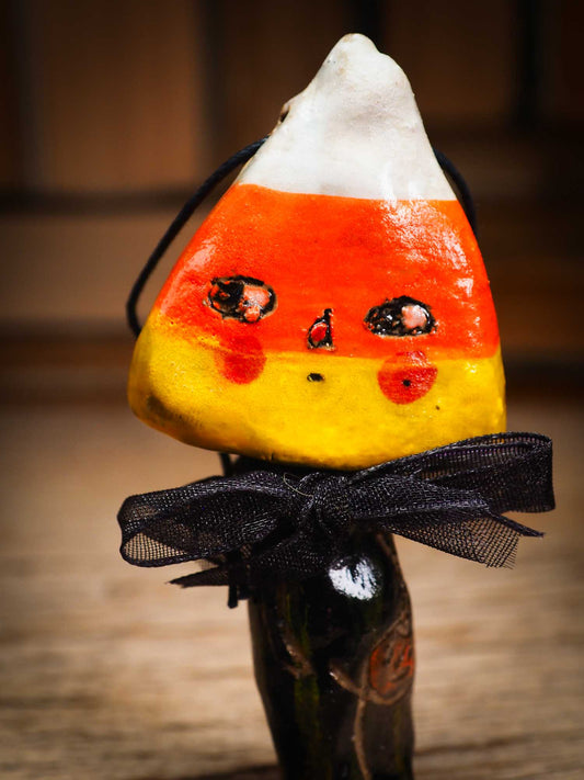 Original handmade ceramic candy corn ornament by Idania Salcido Danita Art with silk bow is perfect Halloween decoration! Stands on its own or hangs from window