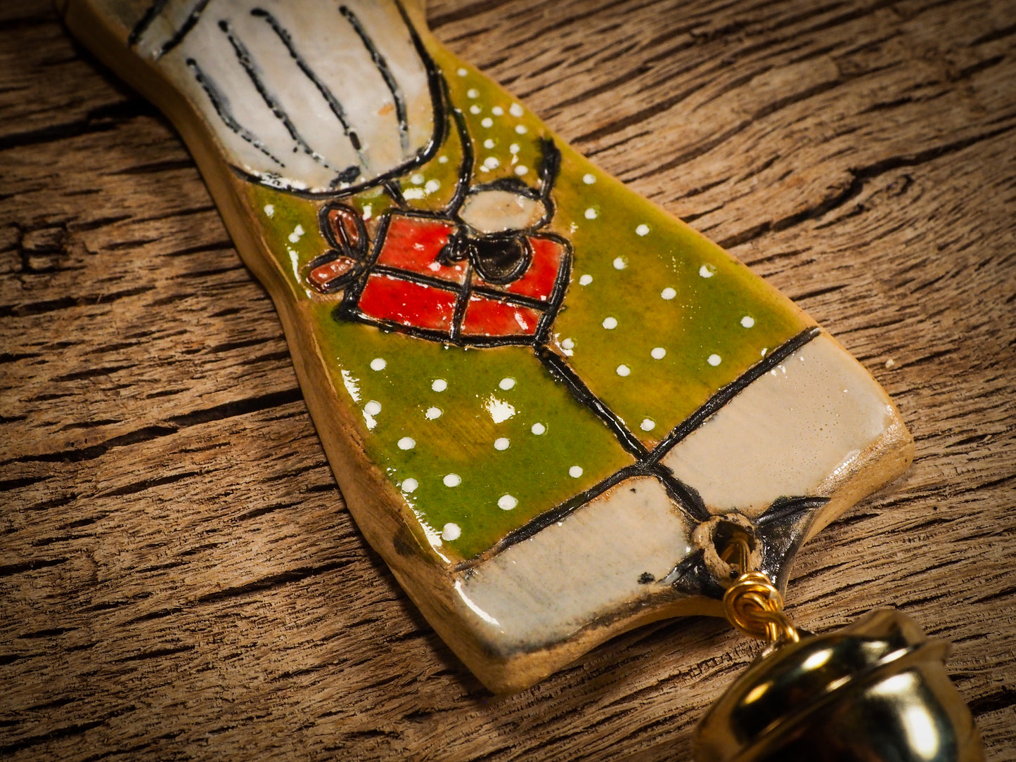 An original Christmas Holiday tree round glazed ceramic ornament handmade by Idania Salcido, the artist behind Danita Art. Glazed carved sgraffito stoneware, hand painted and decorated, it is illustrated by hand with snowmen, Christmas trees, Santa Claus, angels and snow balls and winter themes.