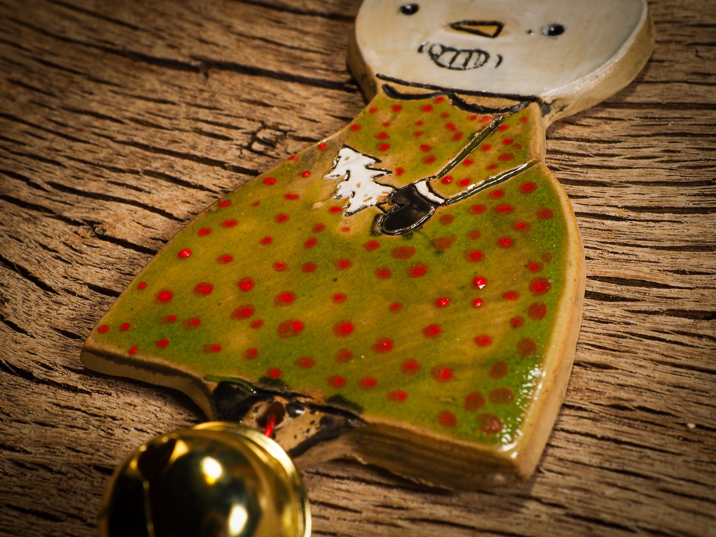 An original Christmas Holiday tree round glazed ceramic ornament handmade by Idania Salcido, the artist behind Danita Art. Glazed carved sgraffito stoneware, hand painted and decorated, it is illustrated by hand with snowmen, Christmas trees, Santa Claus, angels and snow balls and winter themes.