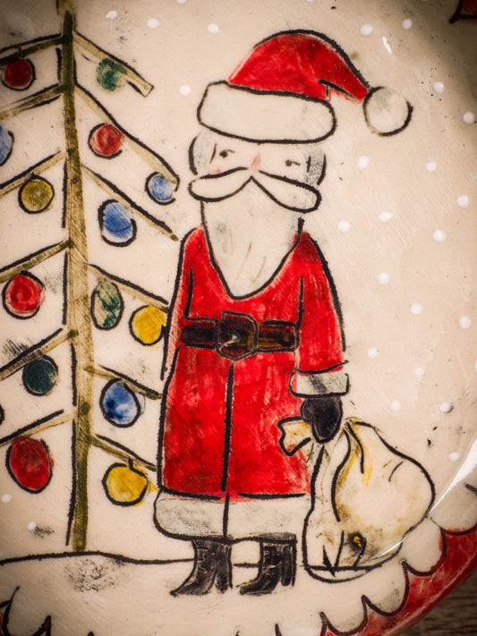 An original Christmas Holiday cake dinner plate round glazed ceramic dinnerware handmade by Idania Salcido, the artist behind Danita Art. Glazed carved sgraffito stoneware, hand painted and decorated, it is illustrated by hand with snowmen, Christmas trees, Santa Claus, angels and snow balls and winter themes.