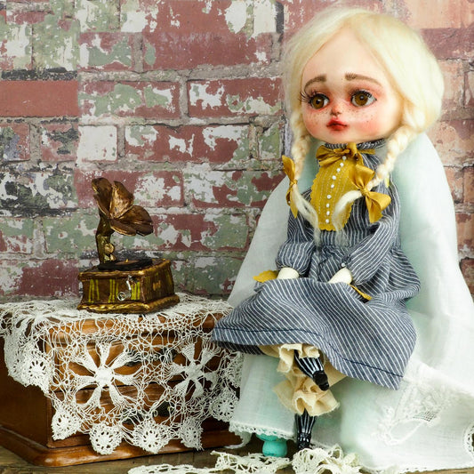 An original hand crafted art doll made by Danita. A blonde girl with a love for music, she plays her vintage vinyl records on her antique gramophone.