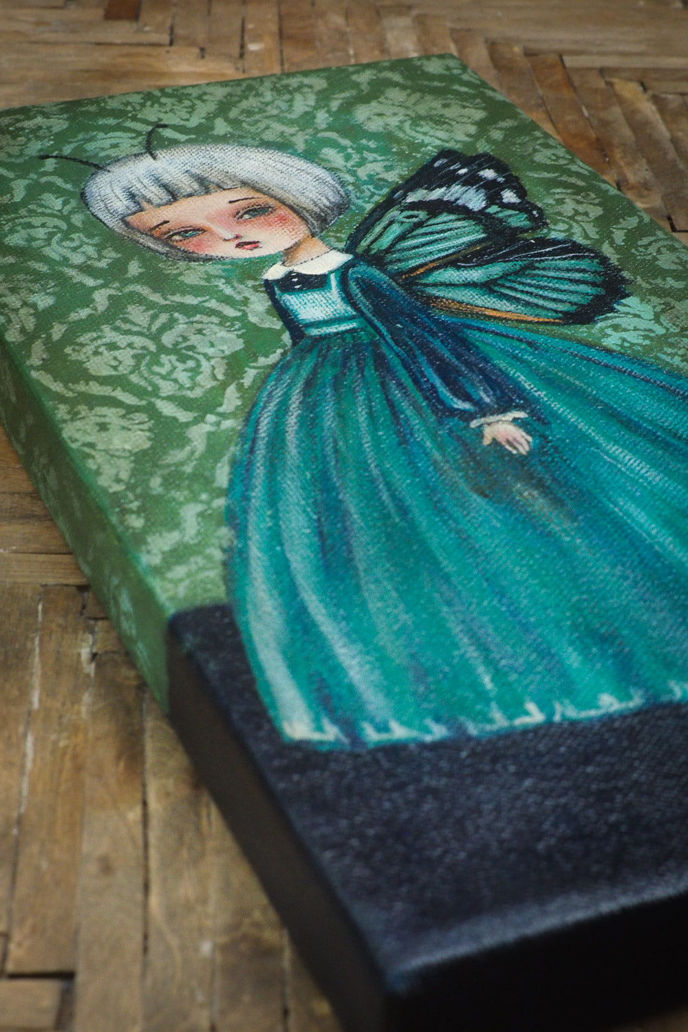 Danita butterfly surrealist folk art painting. Melancholic surreal illustration of moth woman in blue and green.
