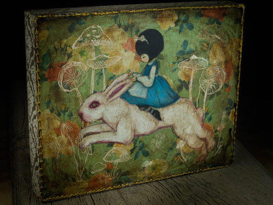 Alice finally caught up with the white rabbit on this surreal painting by Danita, and now they ride together in Wonderland, looking for new adventures for which they will never be late.