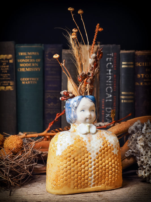 Original handmade ceramic flower vase, artist brush and pencil holder by Idania Salcido, Danita Art. A honeycomb bee shaped statue with china doll head. Handmade touch to any artist's studio with handmade glazed ceramic good for watercolors acrylics inks and oil paints. Clean with water or mineral spirits.