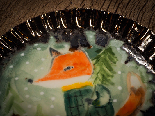 An original Christmas Holiday cake dinner dessert plate round glazed ceramic dinnerware handmade by Idania Salcido, the artist behind Danita Art. Glazed carved sgraffito stoneware, hand painted and decorated, it is illustrated by hand with snowmen, Christmas trees, Santa Claus, angels and snowballs and winter themes.