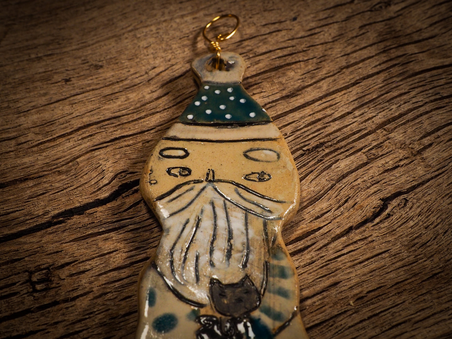 An original Christmas Holiday tree round glazed ceramic ornament handmade by Idania Salcido, the artist behind Danita Art. Glazed carved sgraffito stoneware, hand painted and decorated, it is illustrated by hand with snowmen, Christmas trees, Santa Claus, angels and snow balls and winter themes.