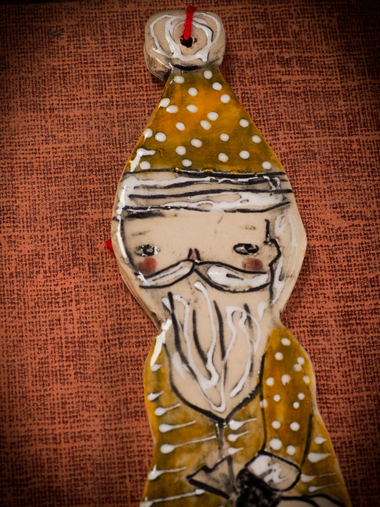 An original Christmas Holiday tree round glazed ceramic ornament handmade by Idania Salcido, the artist behind Danita Art. Glazed carved sgraffito stoneware, hand painted and decorated, it is illustrated by hand with snowmen, Christmas trees, Santa Claus, angels and snow balls and winter themes.