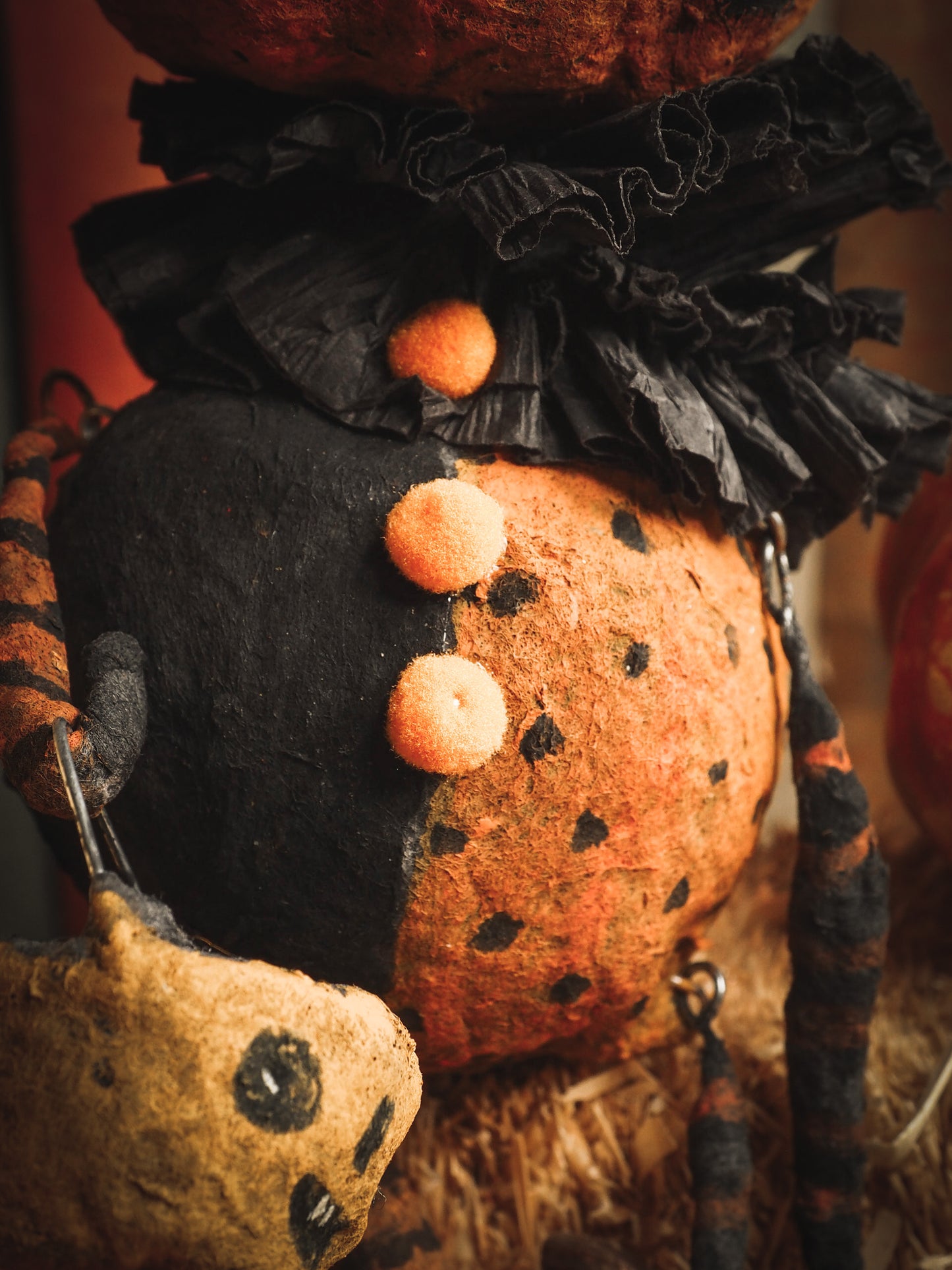 This adorable Halloween handmade ornament pumpkin jack-o-lantern doll monster by Idania Salcido, the artist behind Danita Art, is made with painted spun cotton and paper. It has hand painted face, teeth and eyes with a glittery paper had and matching paper costume. A Halloween home decoration on trick-or-treat night.