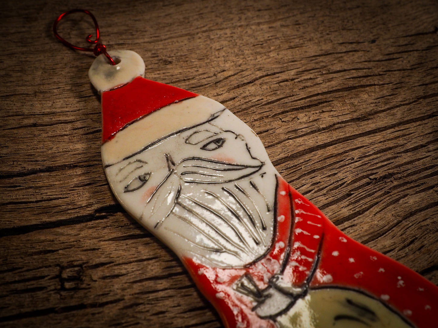 An original Christmas Holiday tree round glazed ceramic ornament handmade by Idania Salcido, the artist behind Danita Art. Glazed carved sgraffito stoneware, hand painted and decorated, it is illustrated by hand with snowmen, Christmas trees, Santa Claus, angels and snow balls and winter themes.
