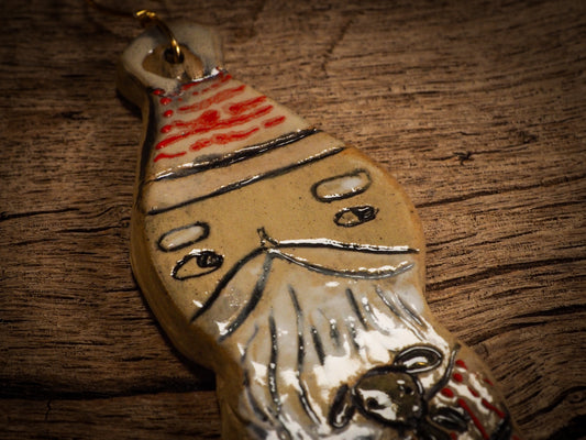 An original Christmas Holiday tree round glazed ceramic ornament handmade by Idania Salcido, the artist behind Danita Art. Glazed carved sgraffito stoneware, hand painted and decorated, it is illustrated by hand with snowmen, Christmas trees, Santa Claus, angels and snow balls and winter themes.