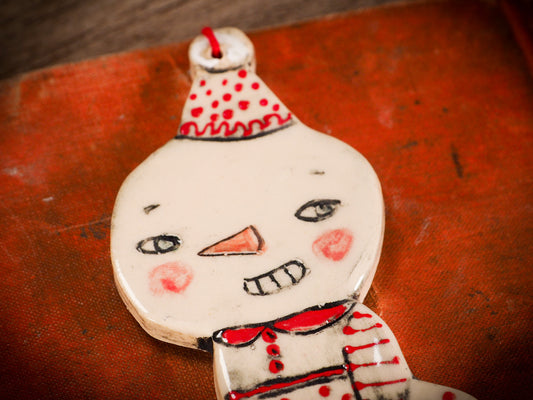 An original Christmas Holiday tree round glazed ceramic ornament handmade by Idania Salcido, the artist behind Danita Art. Glazed carved sgraffito stoneware, hand painted and decorated, it is illustrated by hand with snowmen, Christmas trees, Santa Claus, angels and snow balls and winter themes.