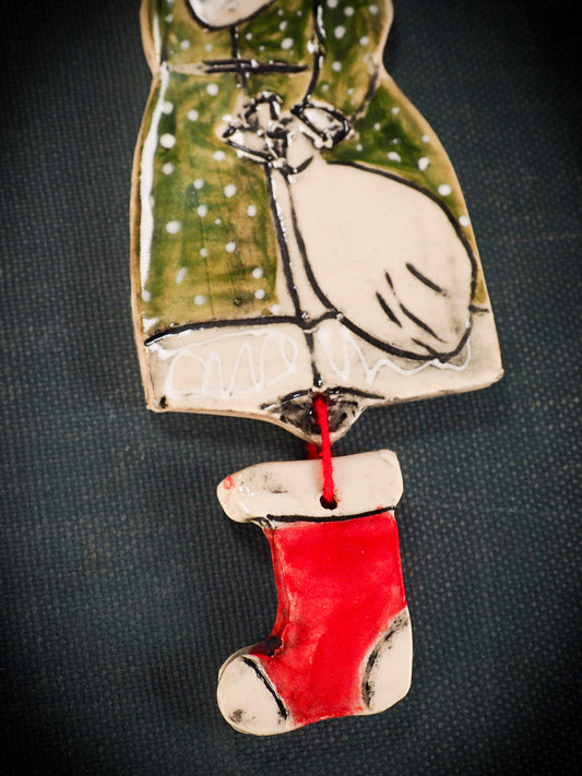 An original Christmas Holiday tree round glazed ceramic ornament handmade by Idania Salcido, the artist behind Danita Art. Glazed carved sgraffito stoneware, hand painted and decorated, it is illustrated by hand with snowmen, Christmas trees, Santa Claus, angels and snow balls and winter themes.