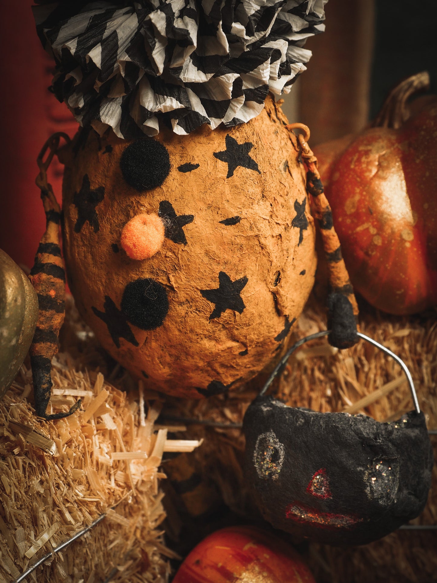 This adorable Halloween handmade ornament pumpkin jack-o-lantern doll monster by Idania Salcido, the artist behind Danita Art, is made with painted spun cotton and paper. It has hand painted face, teeth and eyes with a glittery paper had and matching paper costume. A Halloween home decoration on trick-or-treat night.