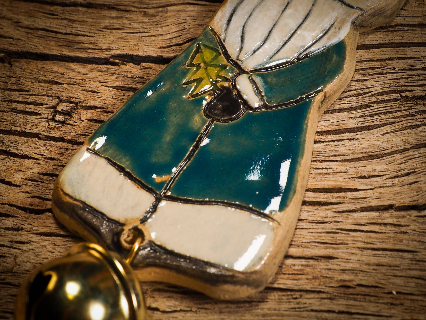 An original Christmas Holiday tree round glazed ceramic ornament handmade by Idania Salcido, the artist behind Danita Art. Glazed carved sgraffito stoneware, hand painted and decorated, it is illustrated by hand with snowmen, Christmas trees, Santa Claus, angels and snow balls and winter themes.