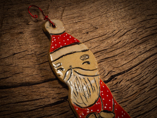 An original Christmas Holiday tree round glazed ceramic ornament handmade by Idania Salcido, the artist behind Danita Art. Glazed carved sgraffito stoneware, hand painted and decorated, it is illustrated by hand with snowmen, Christmas trees, Santa Claus, angels and snow balls and winter themes.