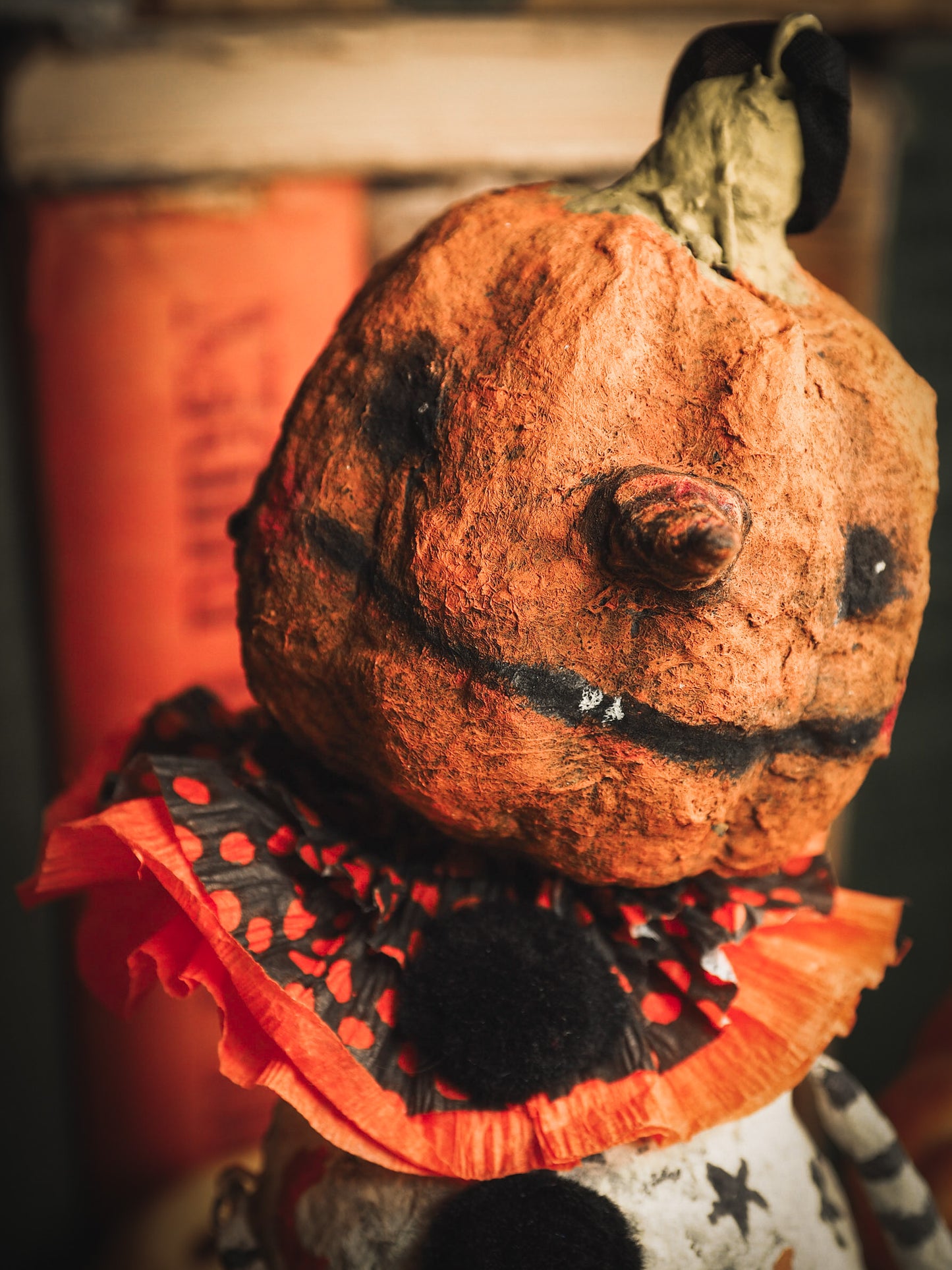 This adorable Halloween handmade ornament pumpkin jack-o-lantern doll monster by Idania Salcido, the artist behind Danita Art, is made with painted spun cotton and paper. It has hand painted face, teeth and eyes with a glittery paper had and matching paper costume. A Halloween home decoration on trick-or-treat night.