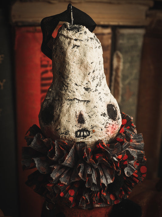 This adorable Halloween handmade ornament pumpkin jack-o-lantern doll monster by Idania Salcido, the artist behind Danita Art, is made with painted spun cotton and paper. It has hand painted face, teeth and eyes with a glittery paper had and matching paper costume. A Halloween home decoration on trick-or-treat night.