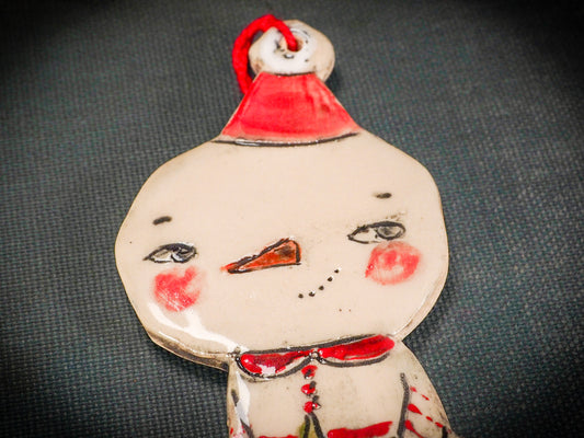 An original Christmas Holiday tree round glazed ceramic ornament handmade by Idania Salcido, the artist behind Danita Art. Glazed carved sgraffito stoneware, hand painted and decorated, it is illustrated by hand with snowmen, Christmas trees, Santa Claus, angels and snow balls and winter themes.