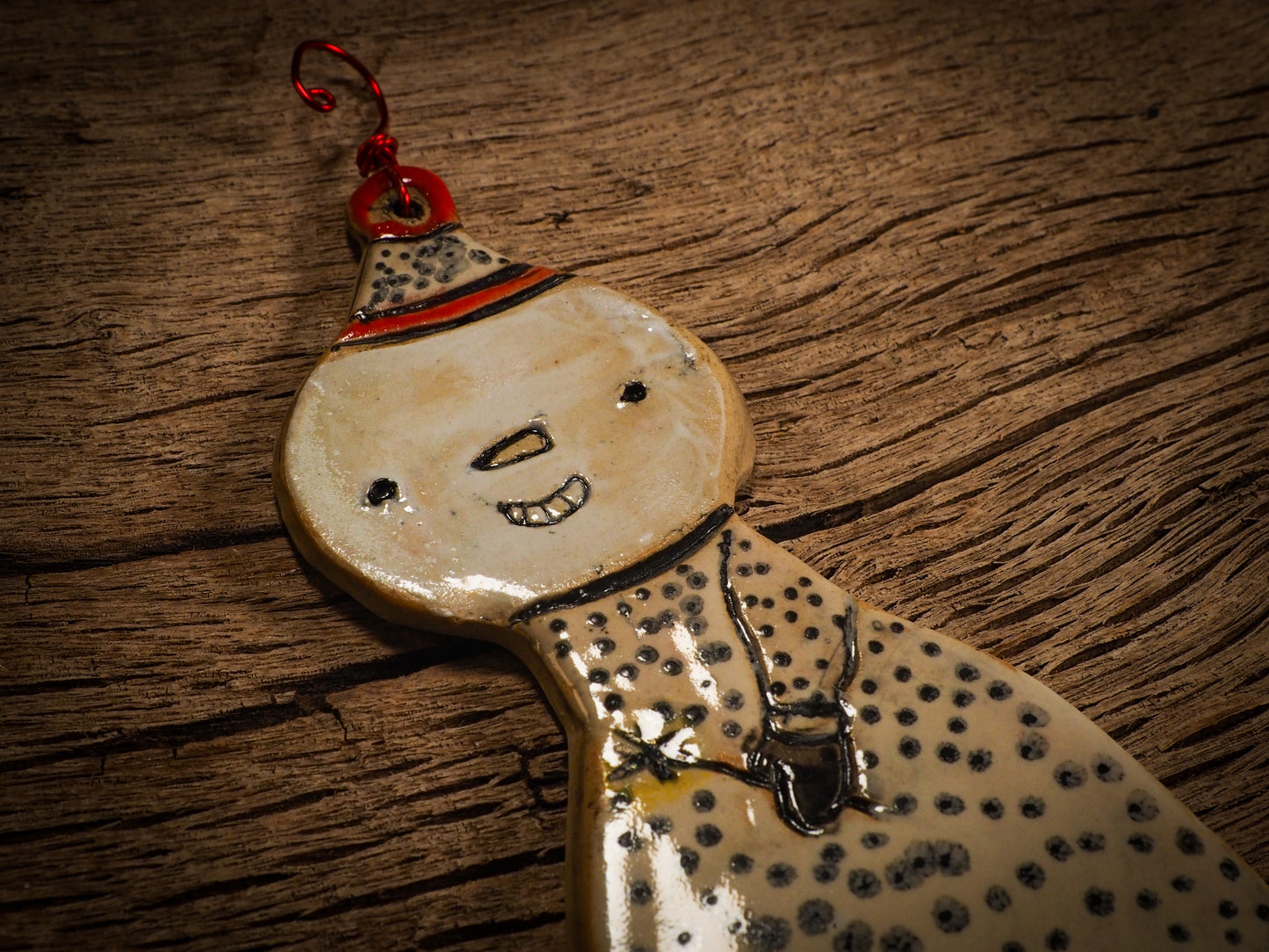 An original Christmas Holiday tree round glazed ceramic ornament handmade by Idania Salcido, the artist behind Danita Art. Glazed carved sgraffito stoneware, hand painted and decorated, it is illustrated by hand with snowmen, Christmas trees, Santa Claus, angels and snow balls and winter themes.