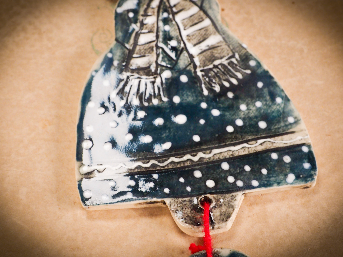 An original Christmas Holiday tree round glazed ceramic ornament handmade by Idania Salcido, the artist behind Danita Art. Glazed carved sgraffito stoneware, hand painted and decorated, it is illustrated by hand with snowmen, Christmas trees, Santa Claus, angels and snow balls and winter themes.