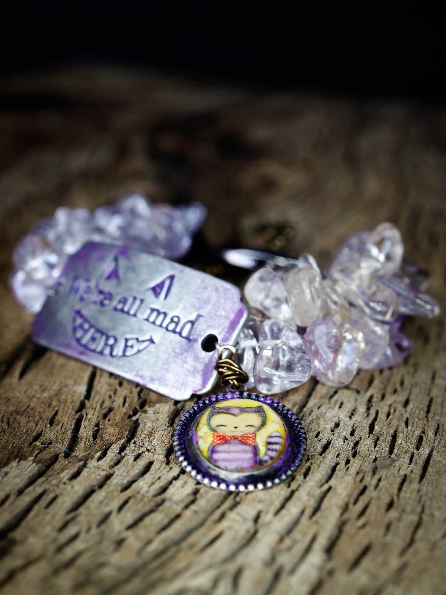 The cheshire cat lives again on this beautiful handmade bracelet with metal, glass and wire wrap jewelry work by Danita Art