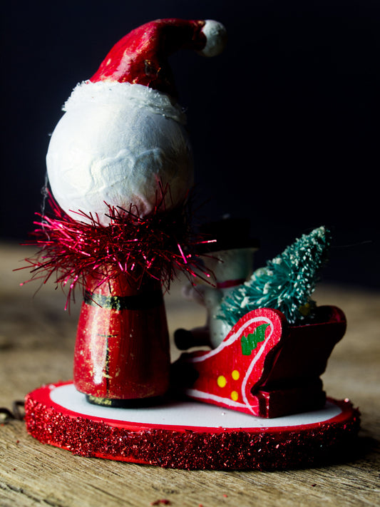 Santa in his magic sled, a holiday wood kokeshi art doll created by Danita Art