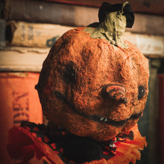 This adorable Halloween handmade ornament pumpkin jack-o-lantern doll monster by Idania Salcido, the artist behind Danita Art, is made with painted spun cotton and paper. It has hand painted face, teeth and eyes with a glittery paper had and matching paper costume. A Halloween home decoration on trick-or-treat night.