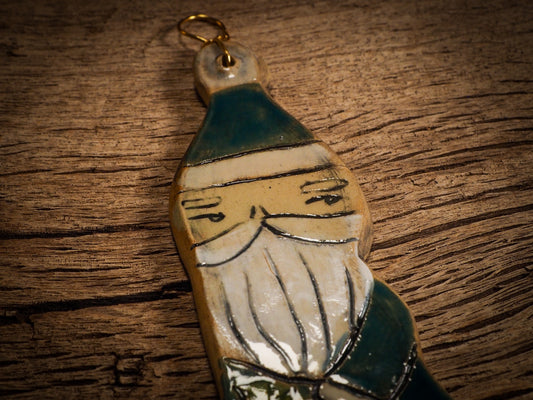 An original Christmas Holiday tree round glazed ceramic ornament handmade by Idania Salcido, the artist behind Danita Art. Glazed carved sgraffito stoneware, hand painted and decorated, it is illustrated by hand with snowmen, Christmas trees, Santa Claus, angels and snow balls and winter themes.