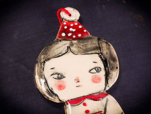 An original Christmas Holiday tree round glazed ceramic ornament handmade by Idania Salcido, the artist behind Danita Art. Glazed carved sgraffito stoneware, hand painted and decorated, it is illustrated by hand with snowmen, Christmas trees, Santa Claus, angels and snow balls and winter themes.