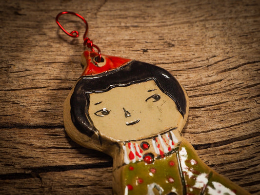 An original Christmas Holiday tree round glazed ceramic ornament handmade by Idania Salcido, the artist behind Danita Art. Glazed carved sgraffito stoneware, hand painted and decorated, it is illustrated by hand with snowmen, Christmas trees, Santa Claus, angels and snow balls and winter themes.