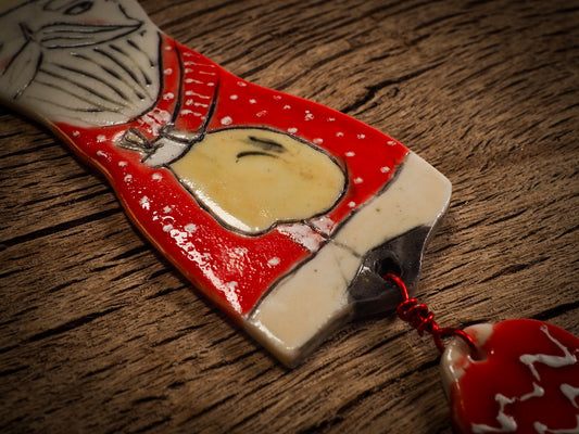 An original Christmas Holiday tree round glazed ceramic ornament handmade by Idania Salcido, the artist behind Danita Art. Glazed carved sgraffito stoneware, hand painted and decorated, it is illustrated by hand with snowmen, Christmas trees, Santa Claus, angels and snow balls and winter themes.