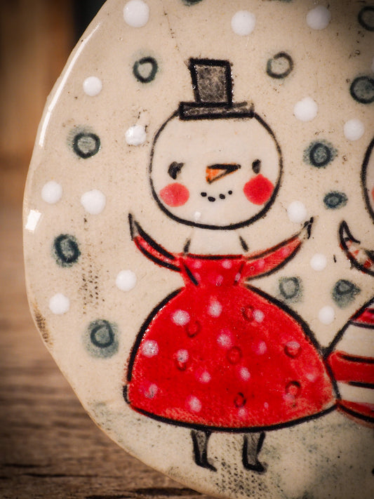 An original Christmas Holiday tree round glazed ceramic ornament handmade by Idania Salcido, the artist behind Danita Art. Glazed carved sgraffito stoneware, hand painted and decorated, it is illustrated by hand with winter scenes with snowmen, Christmas trees, Santa Claus, snow balls and winter themes.