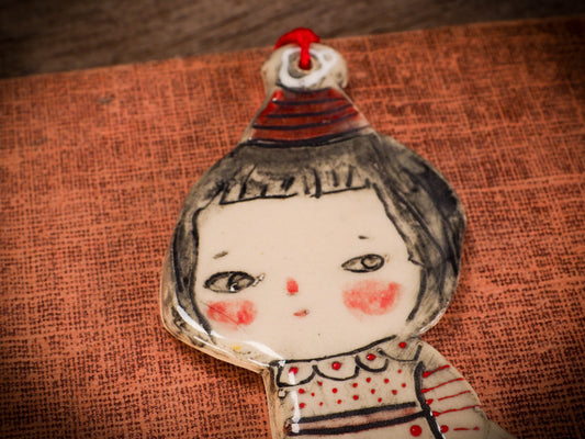 An original Christmas Holiday tree round glazed ceramic ornament handmade by Idania Salcido, the artist behind Danita Art. Glazed carved sgraffito stoneware, hand painted and decorated, it is illustrated by hand with snowmen, Christmas trees, Santa Claus, angels and snow balls and winter themes.