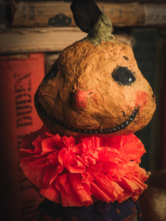 This adorable Halloween handmade ornament pumpkin jack-o-lantern doll monster by Idania Salcido, the artist behind Danita Art, is made with painted spun cotton and paper. It has hand painted face, teeth and eyes with a glittery paper had and matching paper costume. A Halloween home decoration on trick-or-treat night.